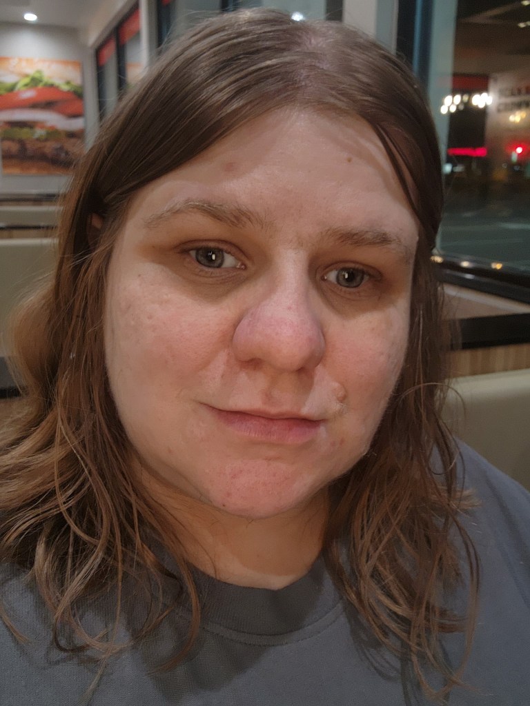 Image of Holly, smiling softly into the camera, radiating kindness, love, and true friendship.